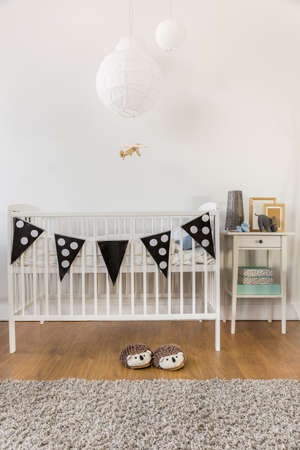 Photo of white wooden crib in kid room