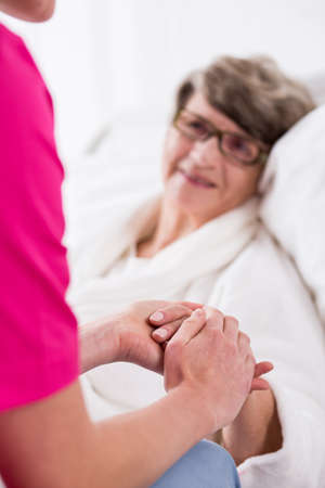 Photo of senior woman having professional private medical careの写真素材