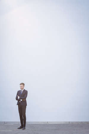 Vertical view of young businessman in big cityの写真素材