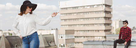 Panorama of hipster pair spending leisure time in the city