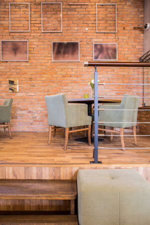 Brick wall and wooden parquet in contemporary restaurantの写真素材