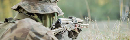 Close-up of masked marine prepared for shooting