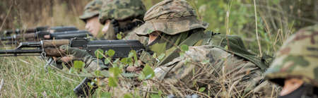 Young soldier on ground with rifle set for shoot