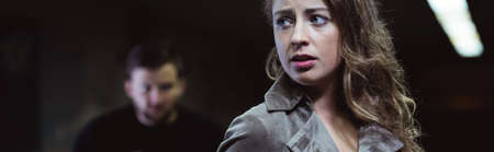 Panorama of beautiful scared young female and dangerous stalker