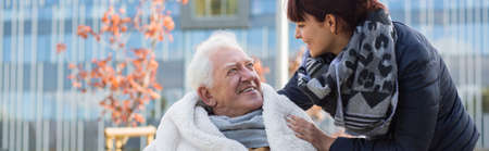 Close relationship between grandfather in wheelchair and granddaughter