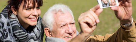 Father and daughter taking selfie portrait at parkの写真素材