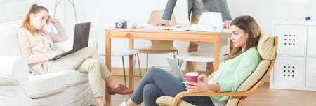 Panorama of creative workers having break at officeの写真素材