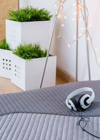 Headphones on the bed in teenager's roomの写真素材