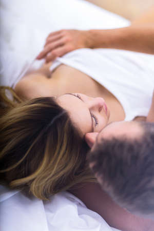 Close-up of sensual foreplay before morning sexの写真素材