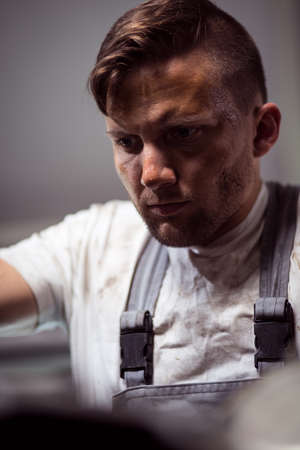 Close up picture showing focused face expression of mechanicの写真素材