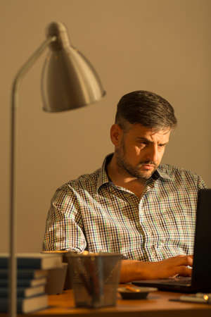 Image of handsome working man sitting at computerの写真素材