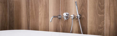 Silver and modern faucet in the bathroomの写真素材