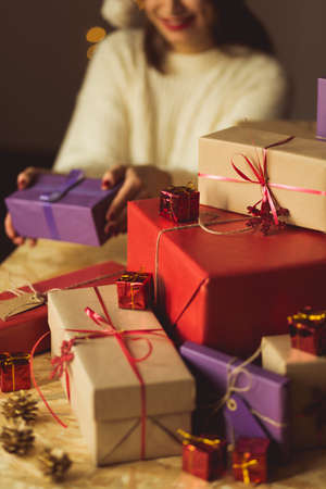 Young woman with heap of xmas presentsの写真素材