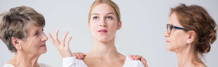 Young confused girl and older generation's womenの写真素材