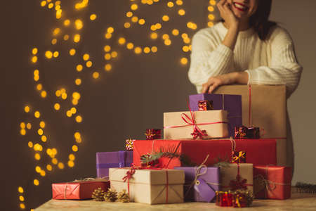 Happy young woman and Christmas gift boxesの写真素材