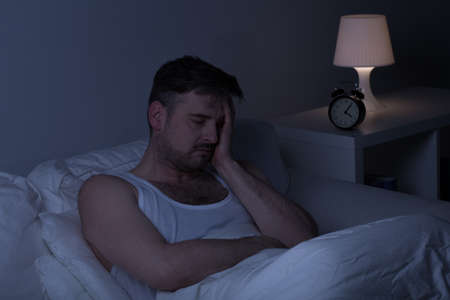 Tired man with insomnia needs some sleepの写真素材