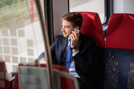 Talking on the phone during way to workの写真素材