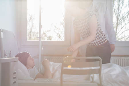 Image of woman visiting suffering from carcinoma child at hospitalの写真素材