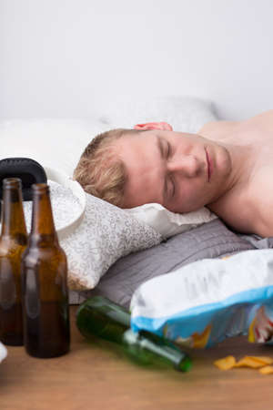 Student is sleeping off after a college partyの写真素材