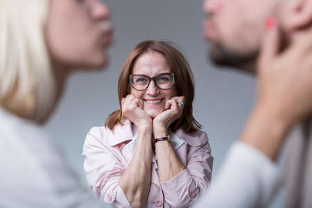 Image of happy mother-in-law and couple in loveの写真素材
