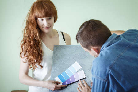 Young woman wants to decorate new flatの写真素材