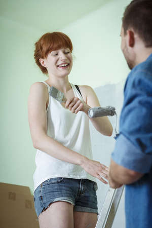 Young couple is having fun during redecorationの写真素材