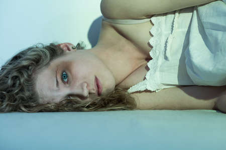 Woman victim lying on the floor with eyes wide open