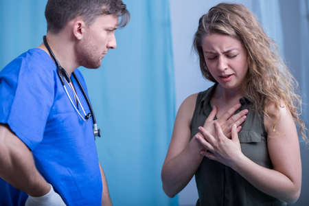 Young doctor interviewing woman in emergency room