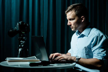 Image of cyber stalker with laptop persecuting his victimの写真素材