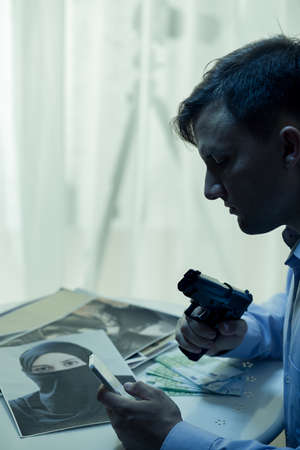 Picture of dangerous mysterious man with gunの写真素材