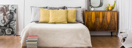 Comfortable bright bedroom for young trendy coupleの写真素材