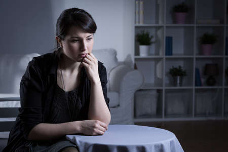 Young woman in black crying after dead husbandの写真素材