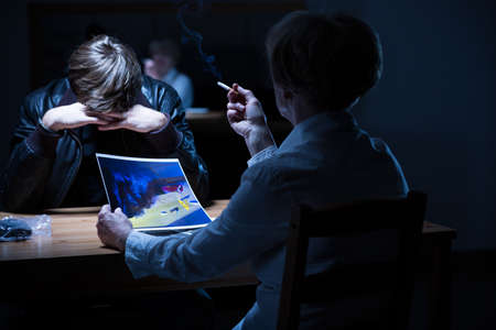 Confrontation with police officer is very stressful for prisonerの写真素材