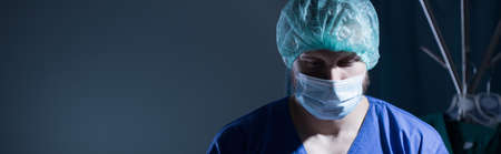 Panorama of surgeon during opeation in sterile medical uniformの写真素材