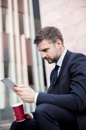 Fashionable businessman is relaxing during coffee breakの写真素材