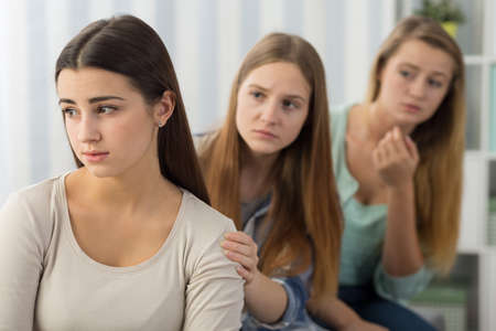 Picture of female friends supporting worried girlの写真素材