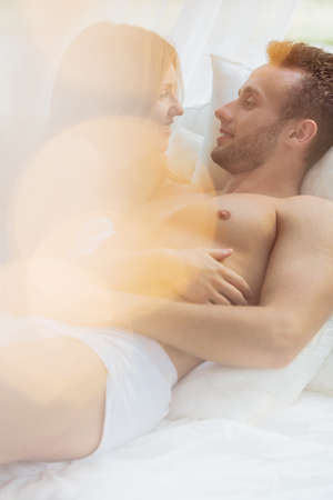 Couple having sensual foreplay at the morning