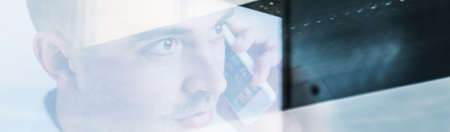 Young man is calling to his bossの写真素材