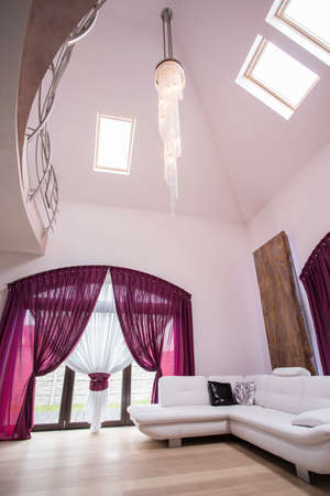 Photo of fancy lounge with big windows and white sofaの写真素材