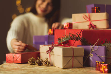 Image of happy lady unpacking christmas presentの写真素材