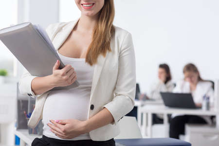 Female chief in pregnancy working in the officeの写真素材