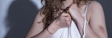 Panorama of abused scared woman with bruisesの写真素材