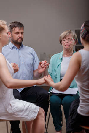 Image of support group during session with psychotherapistの写真素材
