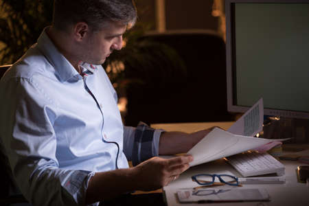 Busy boss has to do lots of paperworkの写真素材