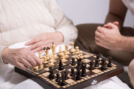 Photo of carer playing chess with rest home residentの写真素材