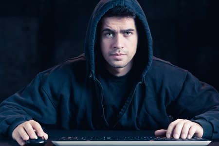 Photo of young cyber warior in black hoody