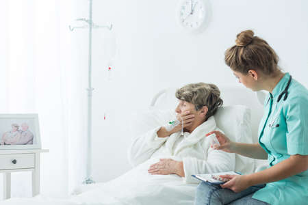 Photo of nurse giving medicines to patientの写真素材