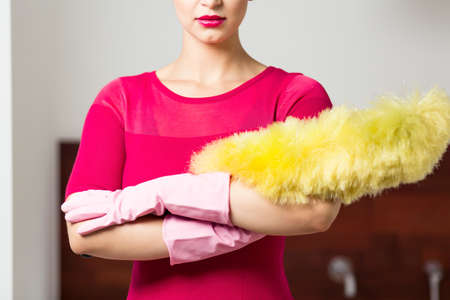 Perfect cleaning lady with feather duster and glovesの写真素材