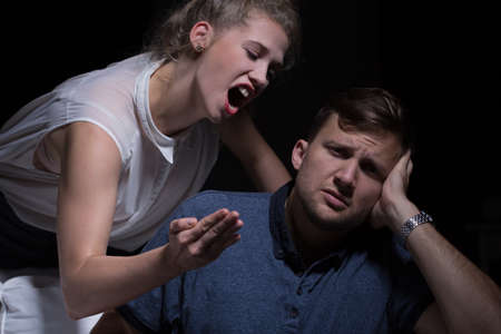 Aggressive young woman yelling at her poor manの写真素材