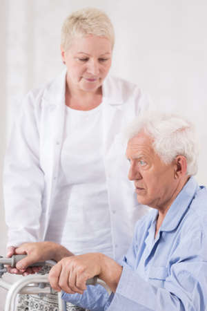 Senior patient recovering from illness and trying to walkの写真素材